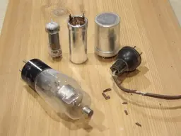 Vintage electronics and old radio equipment on a workbench